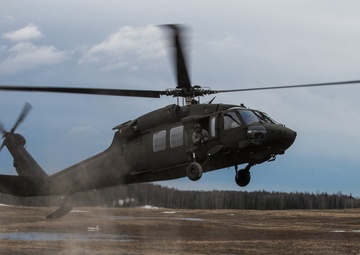 USARAK Soldiers parachute from Black Hawks