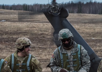 USARAK Soldiers parachute from Black Hawks