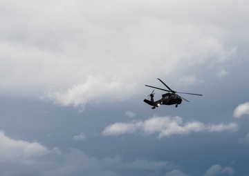 USARAK Soldiers parachute from Black Hawks