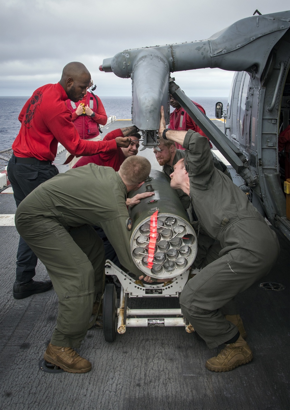 LAU-61 rocket launcher onload to an MH-60S Seahawk helicopter of HSC-22