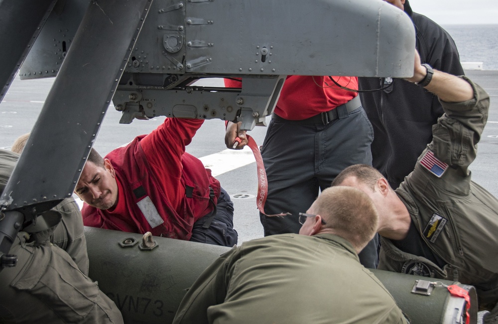 LAU-61 rocket launcher onload to an MH-60S Seahawk helicopter of HSC-22