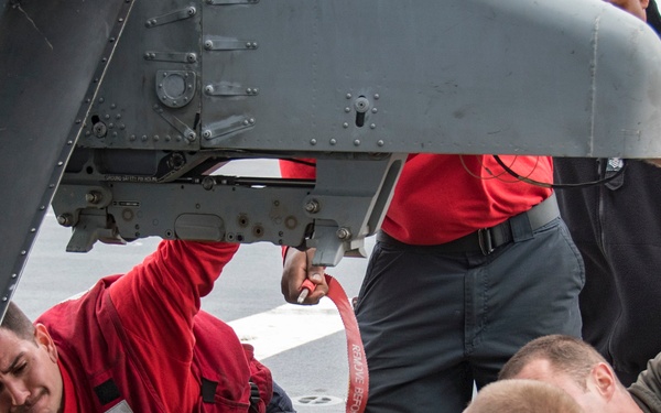 LAU-61 rocket launcher onload to an MH-60S Seahawk helicopter of HSC-22
