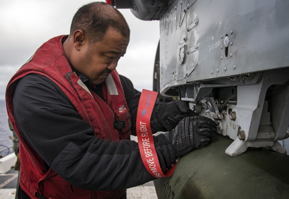 LAU-61 rocket launcher onload to an MH-60S Seahawk helicopter of HSC-22