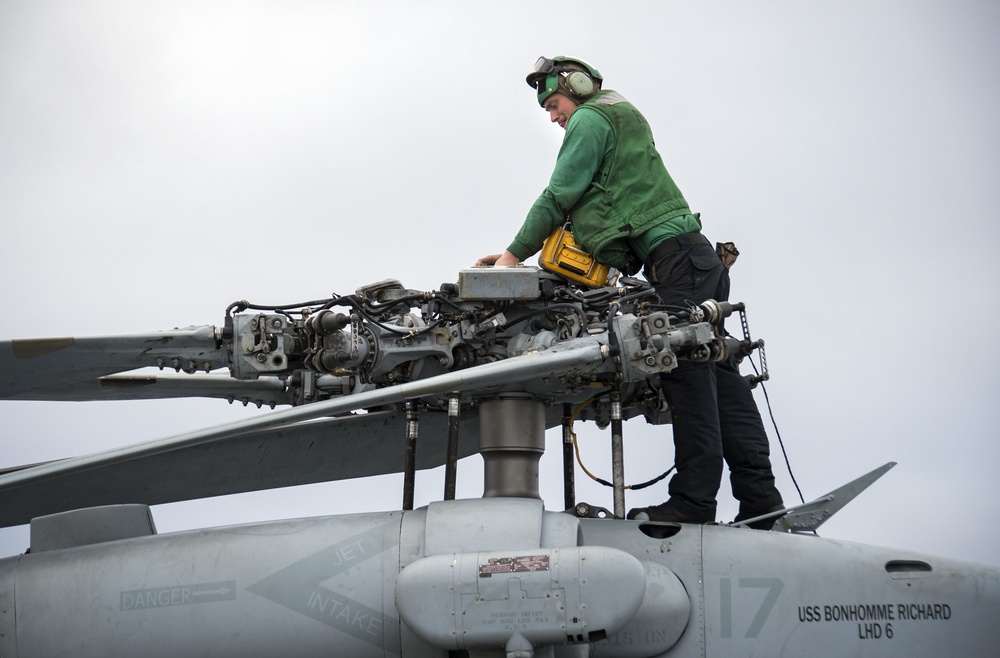 LAU-61 rocket launcher onload to an MH-60S Seahawk helicopter of HSC-22