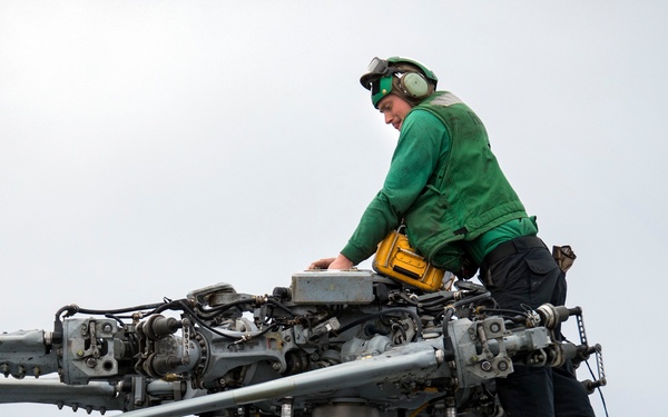 LAU-61 rocket launcher onload to an MH-60S Seahawk helicopter of HSC-22