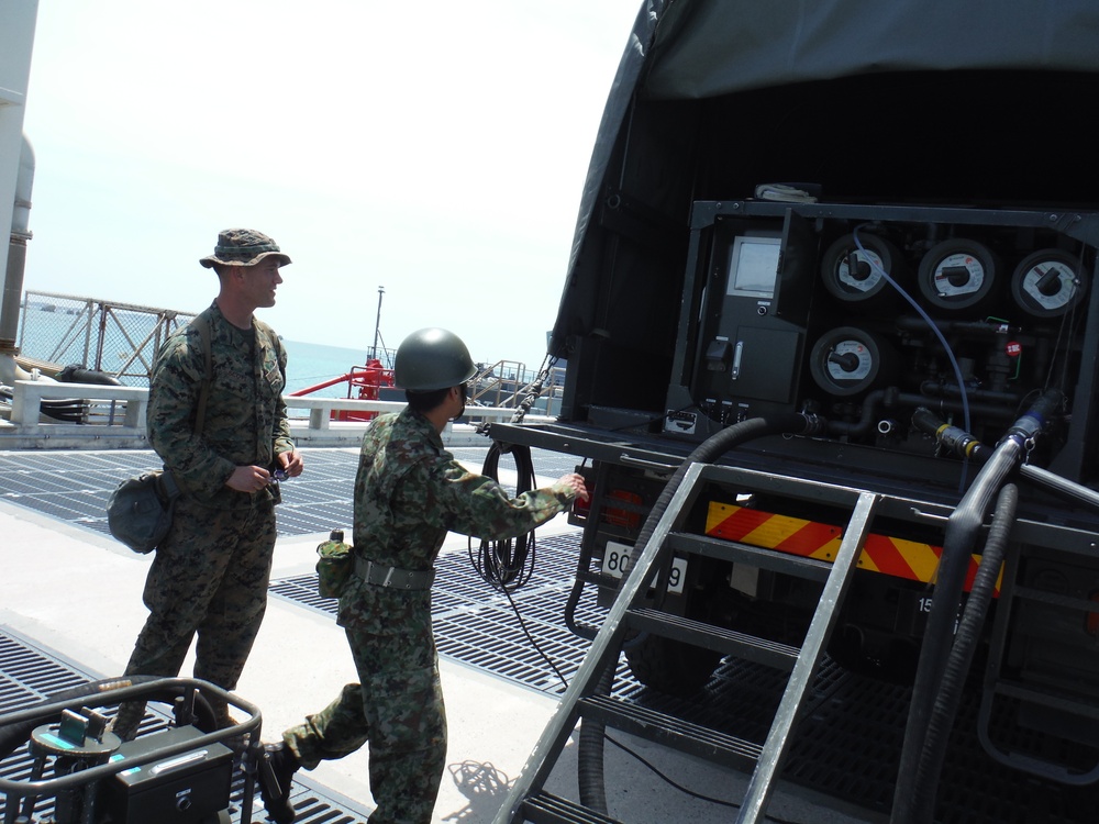 U.S. Marines and Japanese soldiers exchange humanitarian assistance/disaster relief capabilities in Okinawa