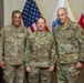 USARCENT command team present coin to hero of the week