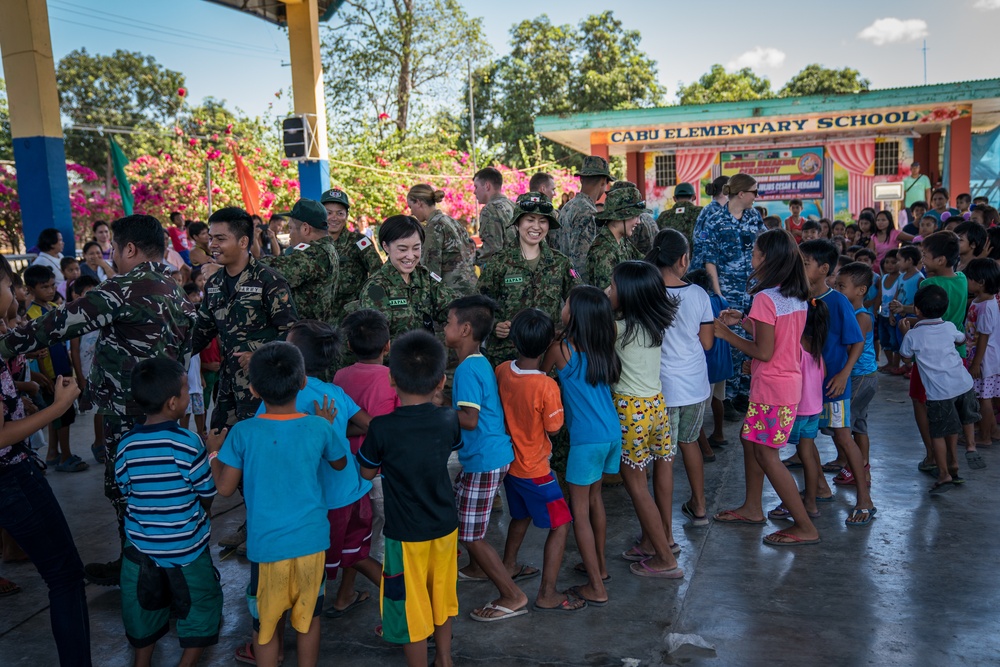 Balikatan 18: Multinational forces sing, dance together at Cabu ES