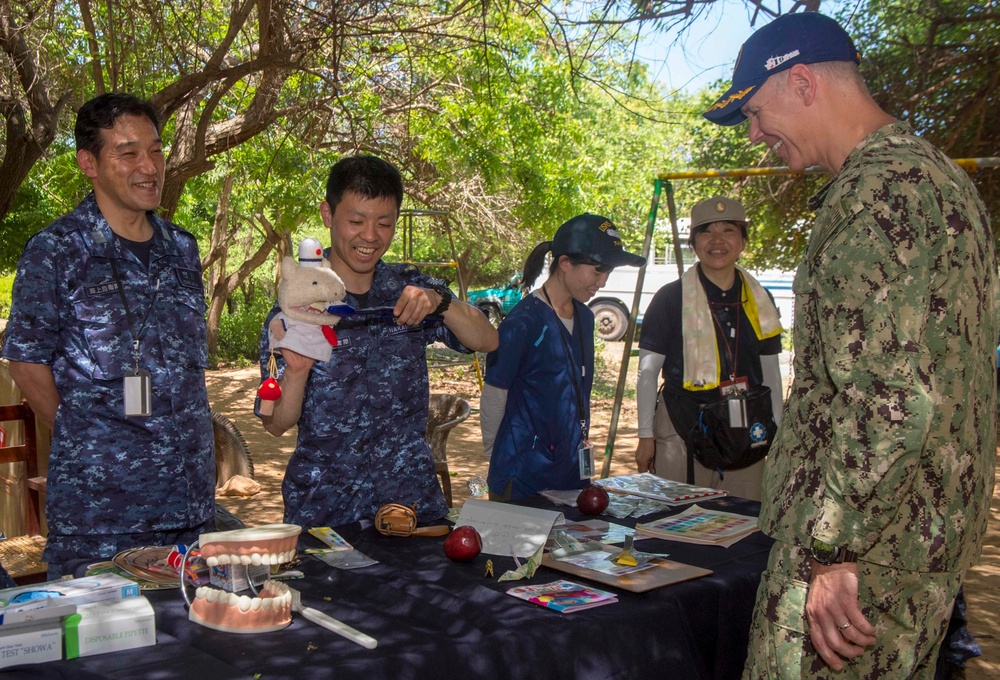 Multi-service dental staff visit patients during a cooperative health exchange.