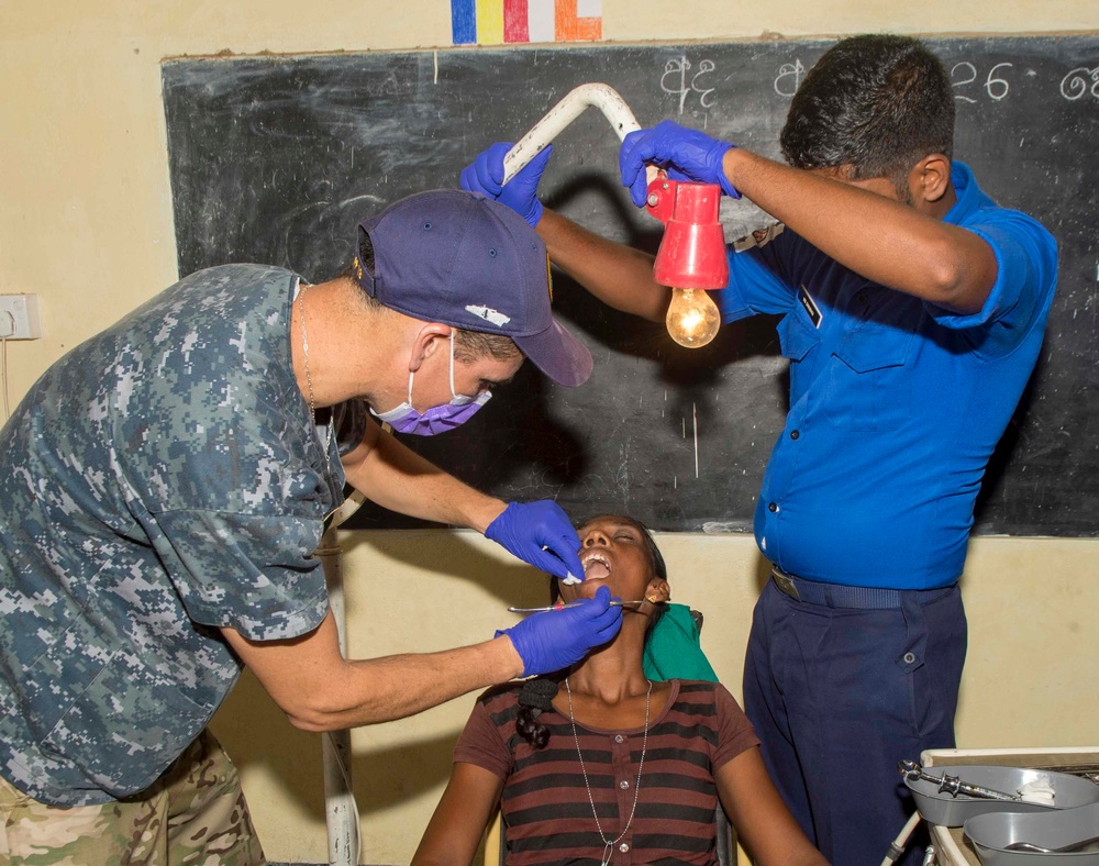 Multi-service dental staff visit patients during a cooperative health exchange.