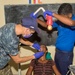 Multi-service dental staff visit patients during a cooperative health exchange.