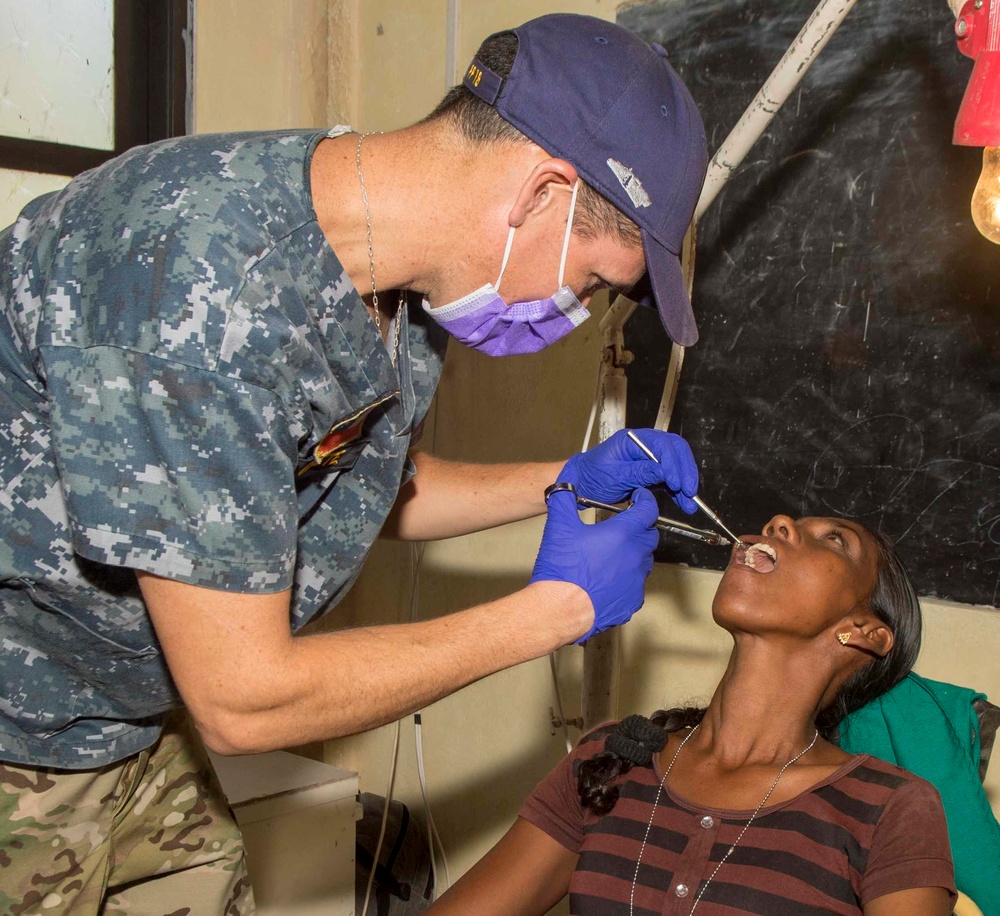 Multi-service dental staff visit patients during a cooperative health exchange.