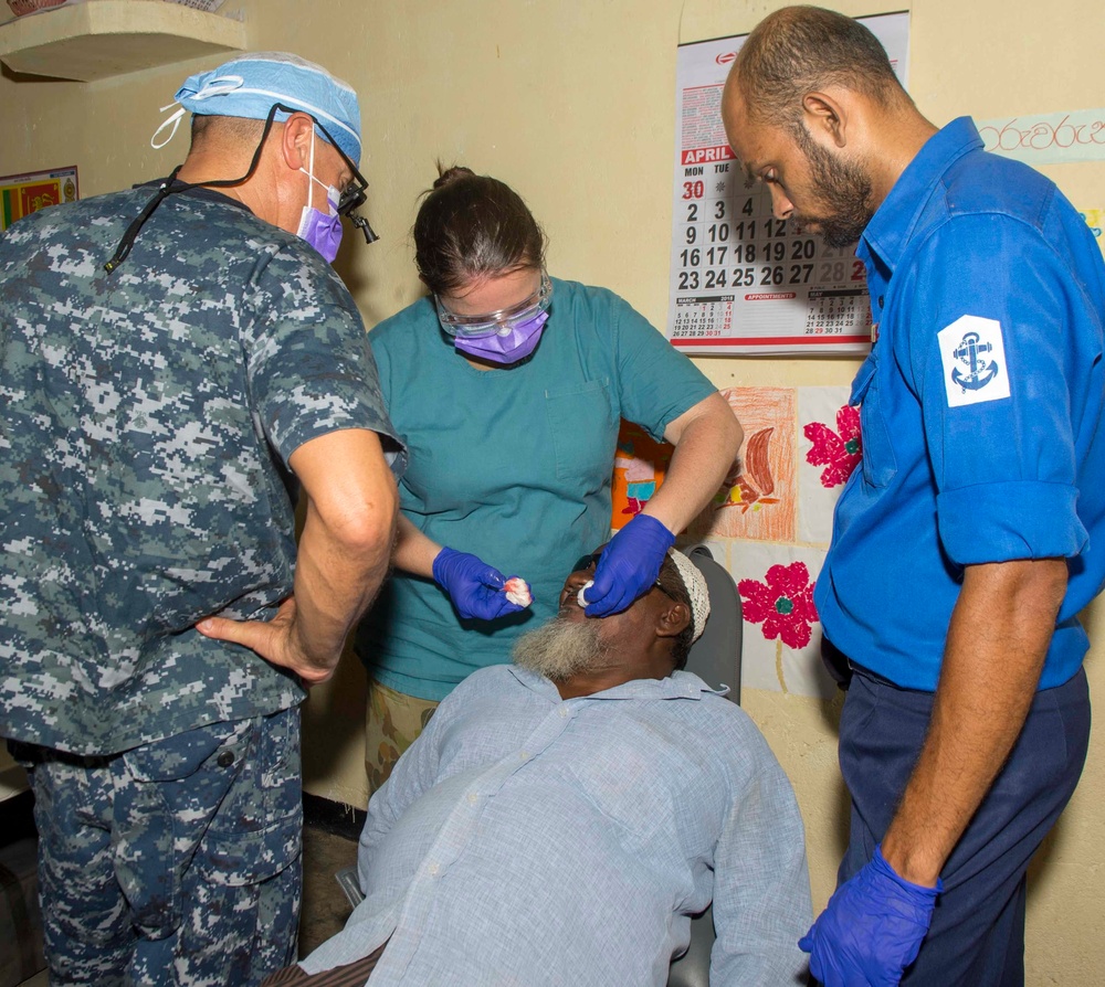 Multi-service dental staff visit patients during a cooperative health exchange.
