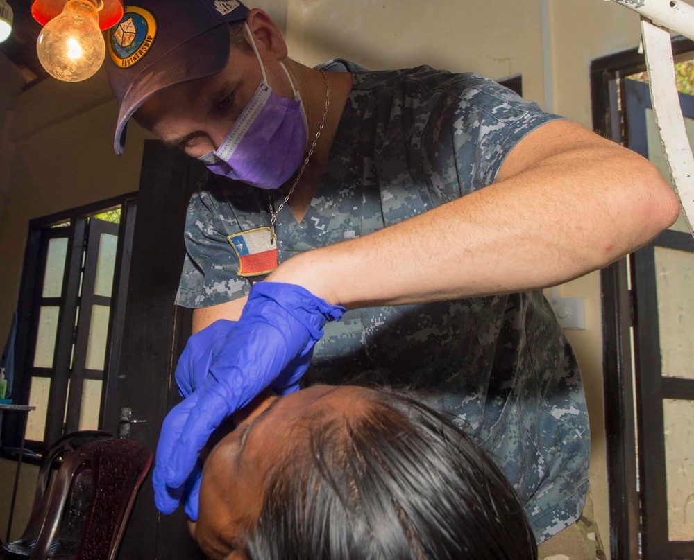 Multi-service dental staff visit patients during a cooperative health exchange.