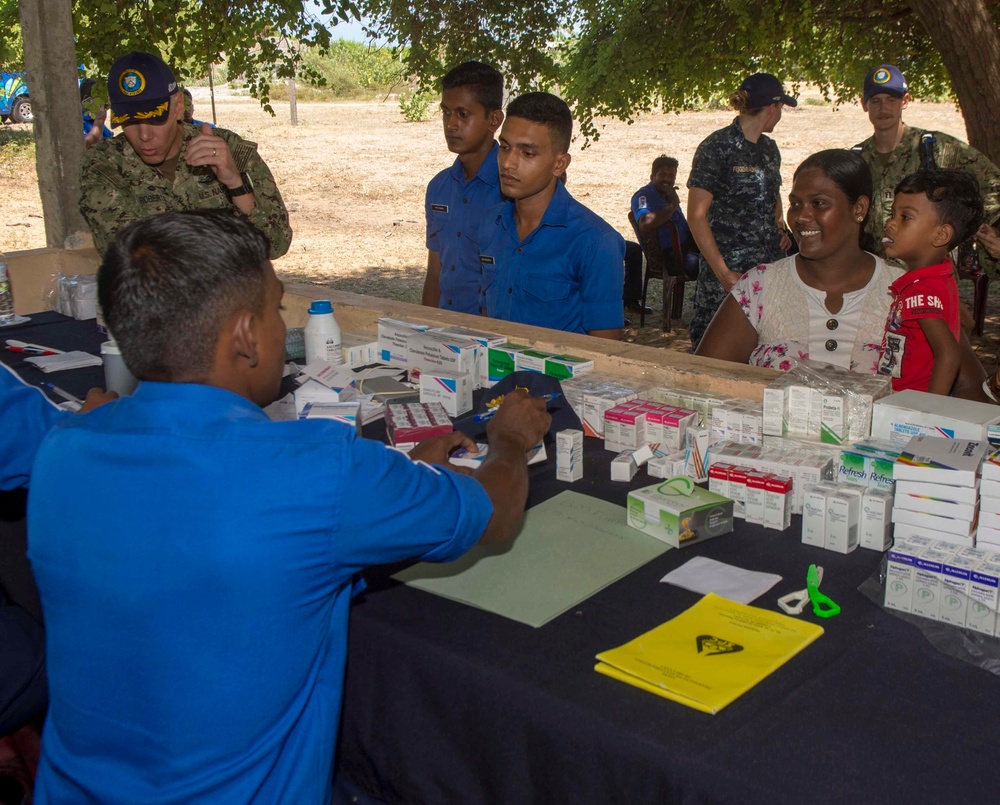 Multi-service dental staff visit patients during a cooperative health exchange.