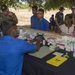 Multi-service dental staff visit patients during a cooperative health exchange.
