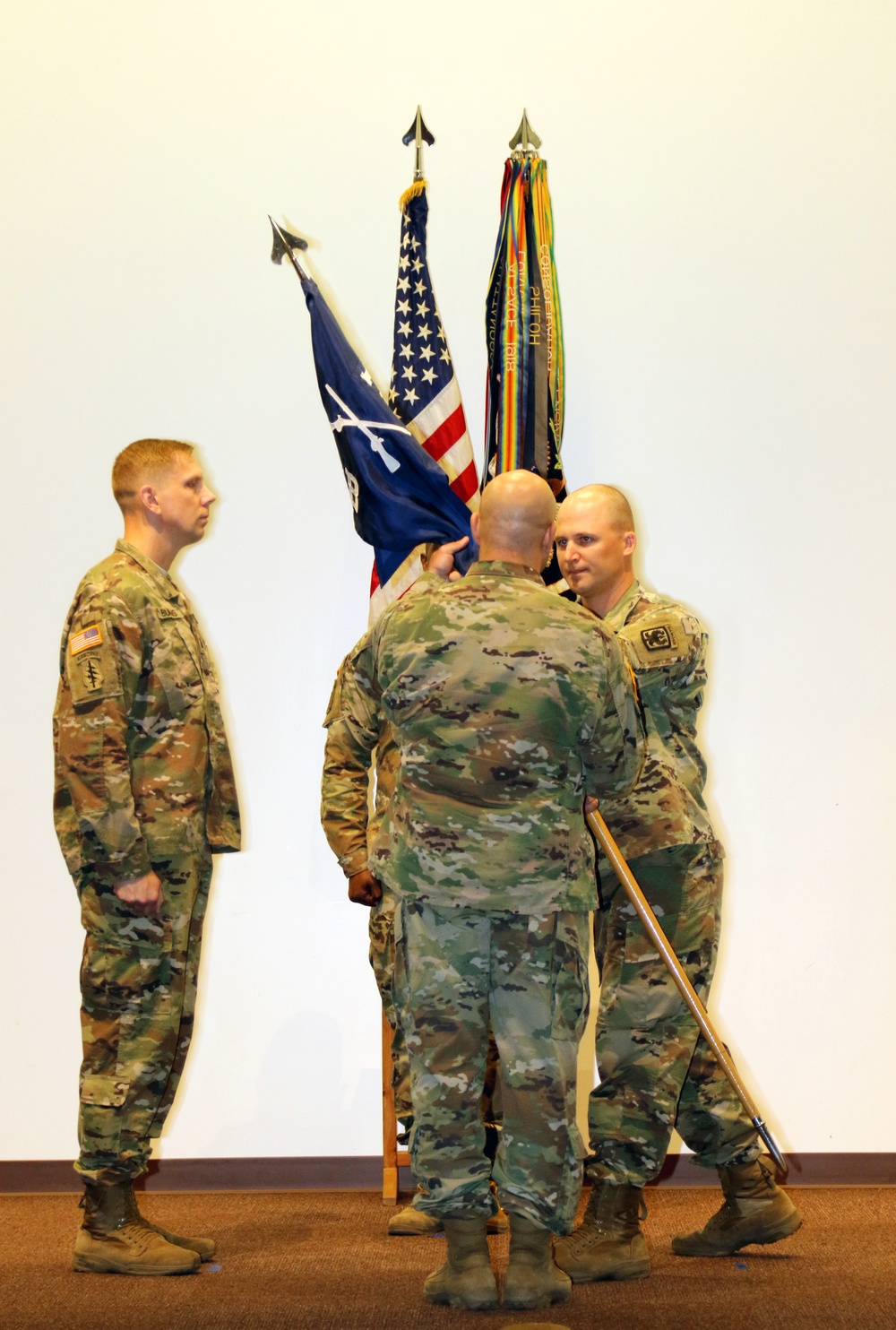 Outgoing Bravo Company commander passes the colors for last time