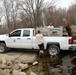 U.S. Fish and Wildlife Service personnel stock trout at Fort McCoy lakes