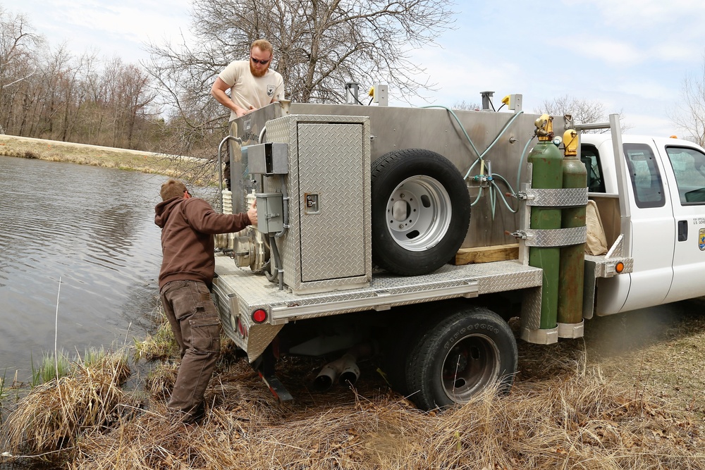 U.S. Fish and Wildlife Service personnel stock trout at Fort McCoy lakes