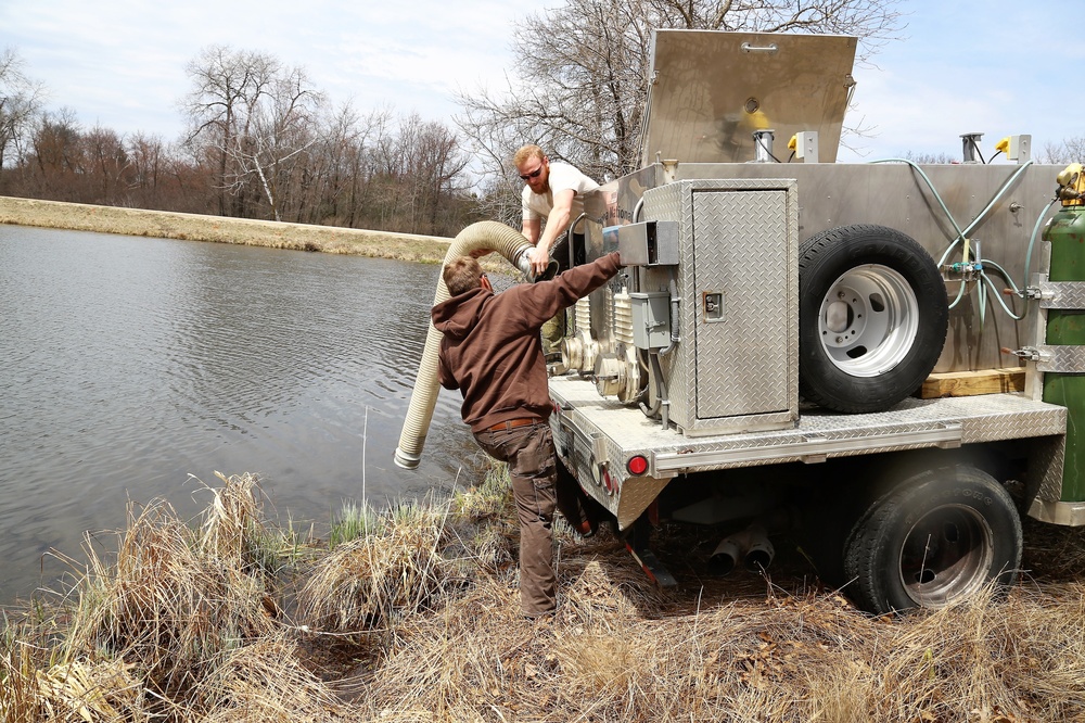 U.S. Fish and Wildlife Service personnel stock trout at Fort McCoy lakes