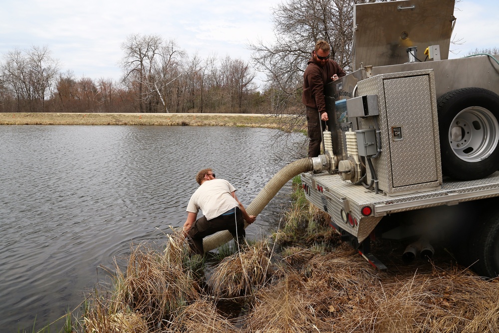 U.S. Fish and Wildlife Service personnel stock trout at Fort McCoy lakes