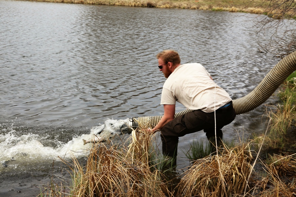 U.S. Fish and Wildlife Service personnel stock trout at Fort McCoy lakes