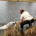 U.S. Fish and Wildlife Service personnel stock trout at Fort McCoy lakes