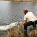 U.S. Fish and Wildlife Service personnel stock trout at Fort McCoy lakes