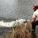 U.S. Fish and Wildlife Service personnel stock trout at Fort McCoy lakes