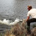 U.S. Fish and Wildlife Service personnel stock trout at Fort McCoy lakes