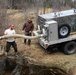 U.S. Fish and Wildlife Service personnel stock trout at Fort McCoy lakes