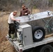 U.S. Fish and Wildlife Service personnel stock trout at Fort McCoy lakes