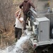 U.S. Fish and Wildlife Service personnel stock trout at Fort McCoy lakes