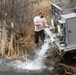 U.S. Fish and Wildlife Service personnel stock trout at Fort McCoy lakes