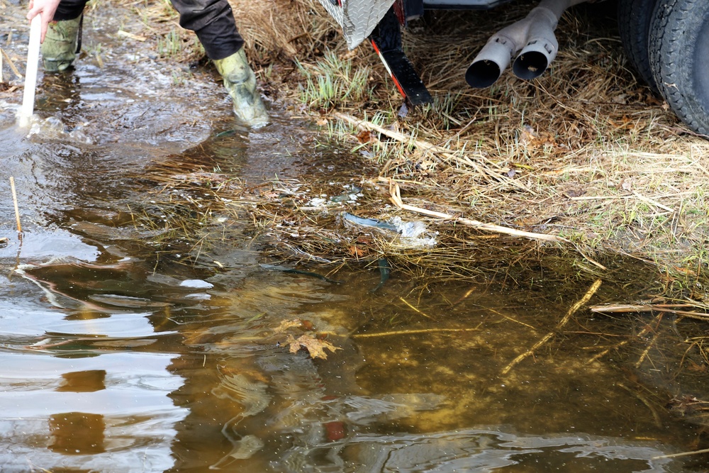 U.S. Fish and Wildlife Service personnel stock trout at Fort McCoy lakes