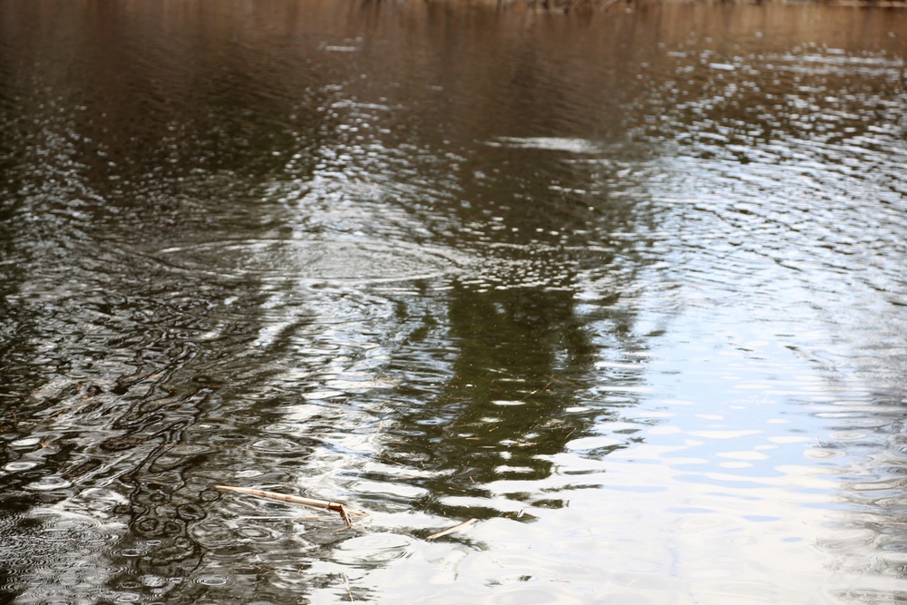 U.S. Fish and Wildlife Service personnel stock trout at Fort McCoy lakes