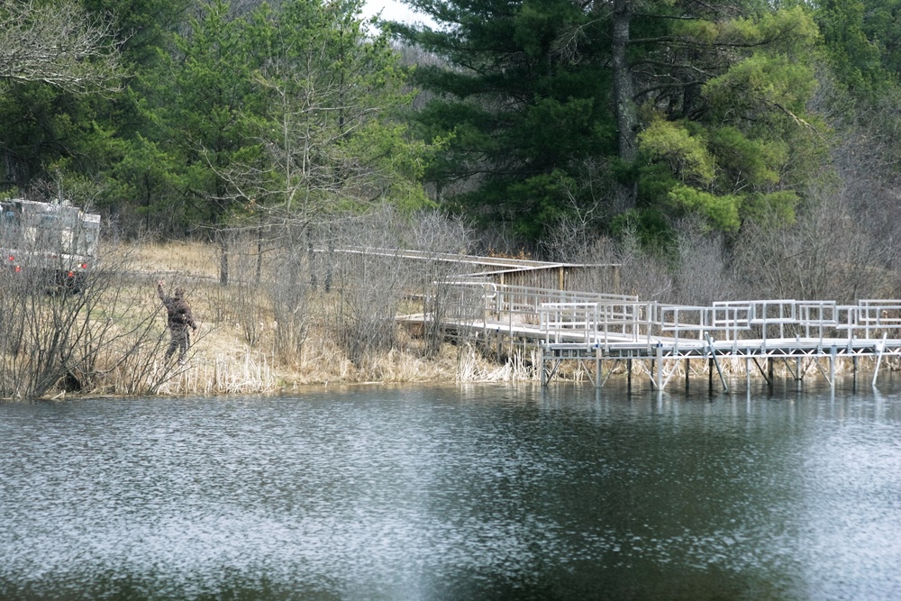 U.S. Fish and Wildlife Service personnel stock trout at Fort McCoy lakes