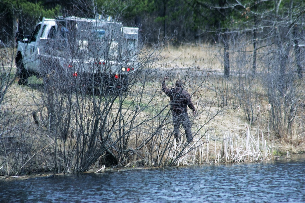 U.S. Fish and Wildlife Service personnel stock trout at Fort McCoy lakes