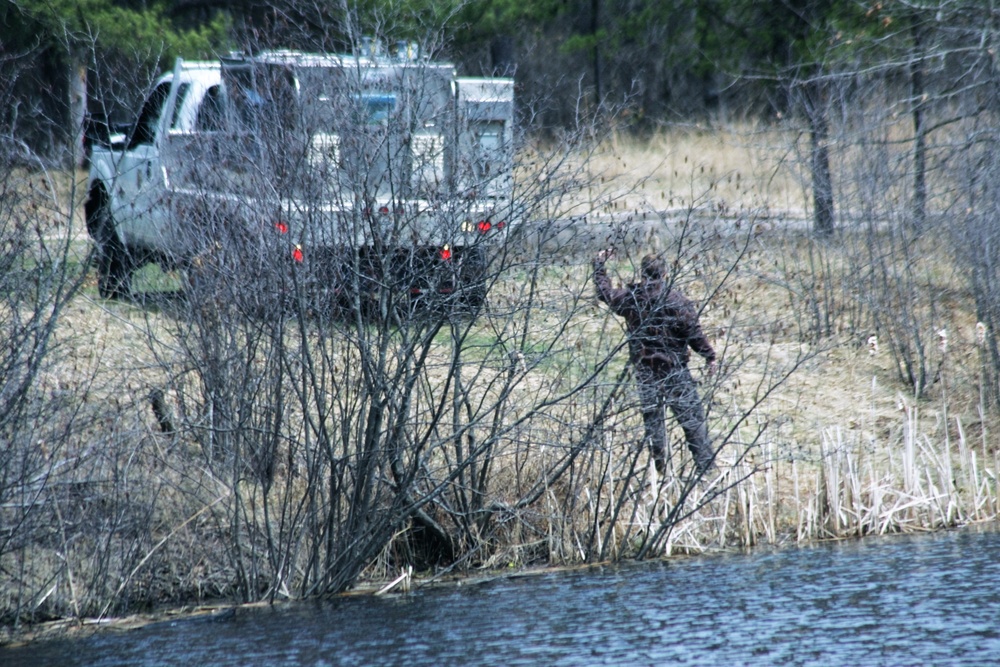 U.S. Fish and Wildlife Service personnel stock trout at Fort McCoy lakes