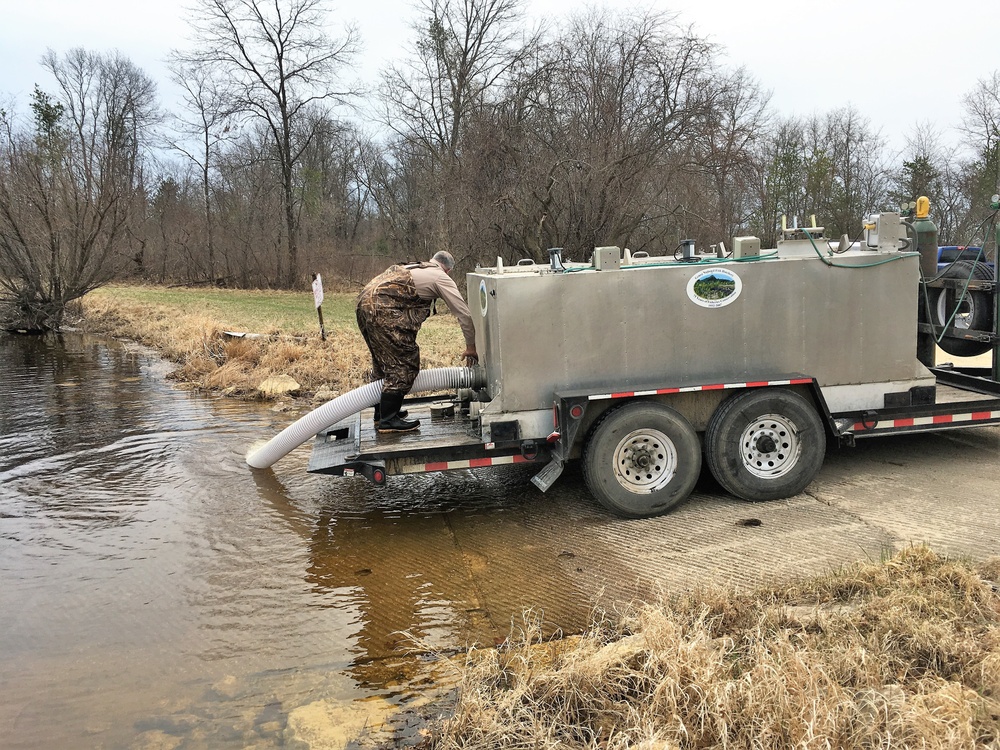 U.S. Fish and Wildlife Service personnel stock trout at Fort McCoy lakes