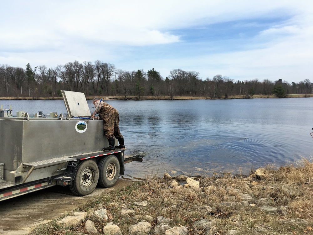 U.S. Fish and Wildlife Service personnel stock trout at Fort McCoy lakes