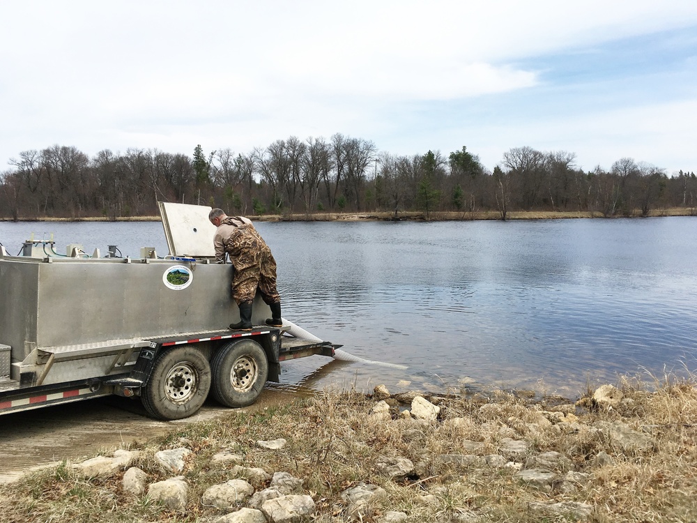 U.S. Fish and Wildlife Service personnel stock trout at Fort McCoy lakes