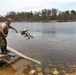 U.S. Fish and Wildlife Service personnel stock trout at Fort McCoy lakes