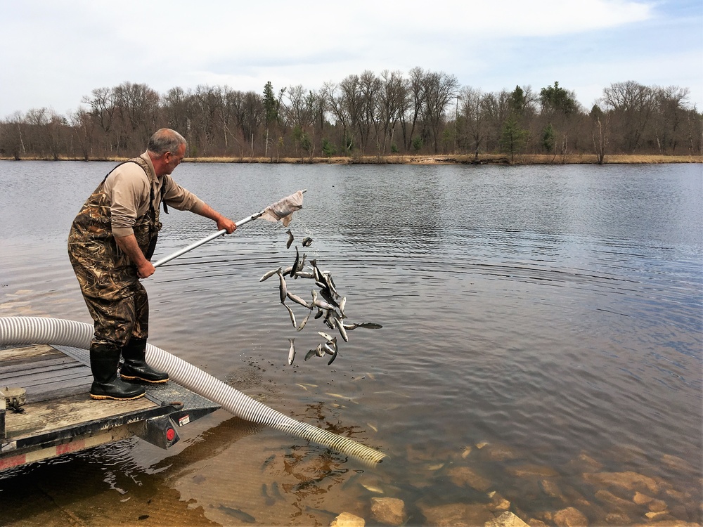 U.S. Fish and Wildlife Service personnel stock trout at Fort McCoy lakes