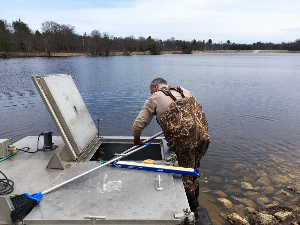 U.S. Fish and Wildlife Service personnel stock trout at Fort McCoy lakes