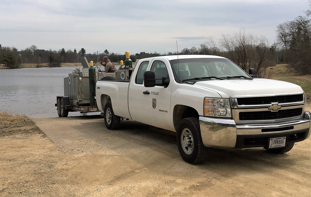 U.S. Fish and Wildlife Service personnel stock trout at Fort McCoy lakes