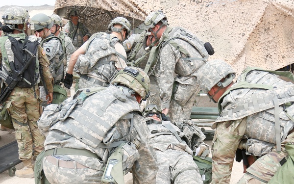 \Soldiers transport casualty using a cot