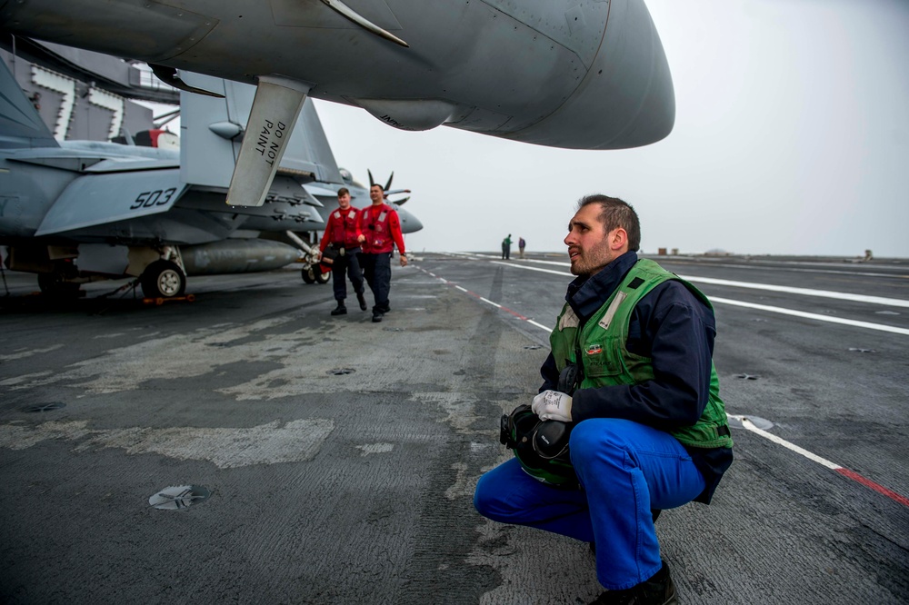 French Sailor Examines Growler Aboard GHWB
