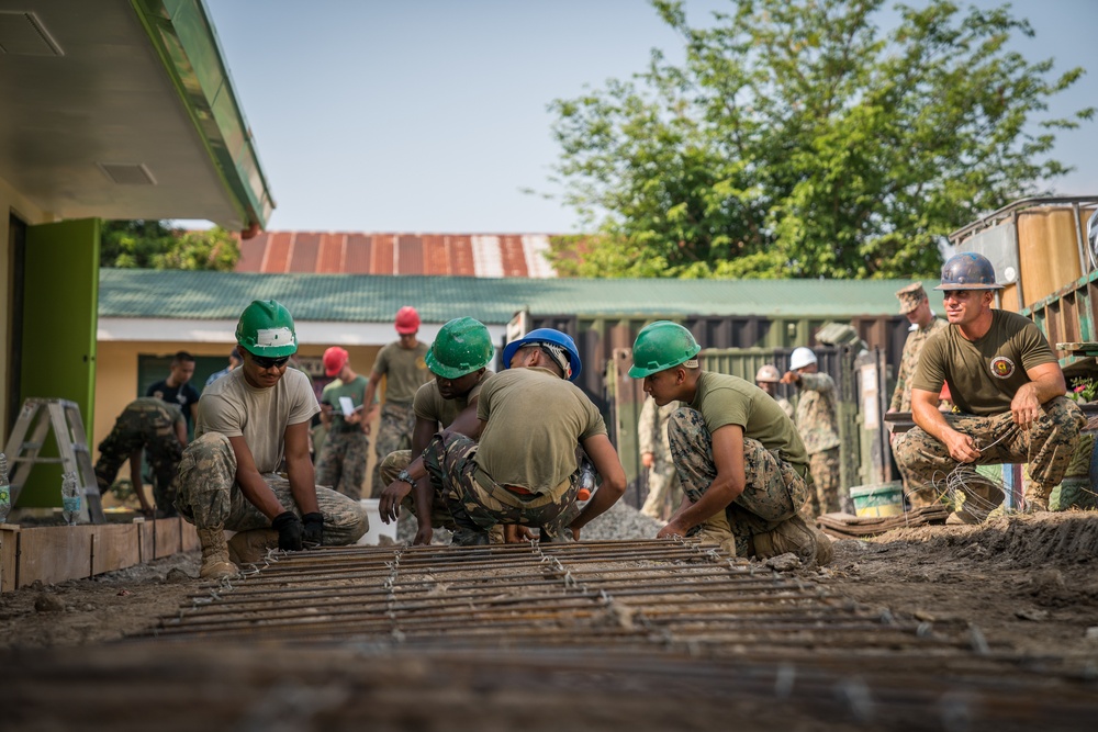 Balikatan 18: Multinational forces add finishing touches to building at Calangitan ES