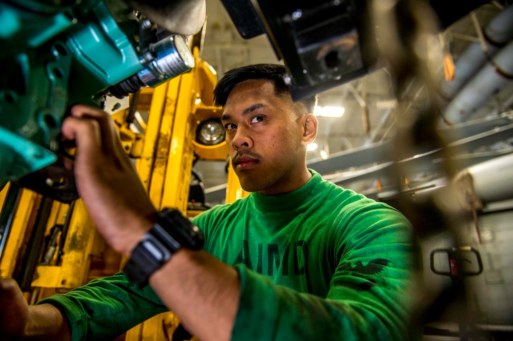 GHWB Sailor conducts maintenance on an engine